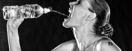 Thirsty Sporty Woman Drinking Water from a Bottle